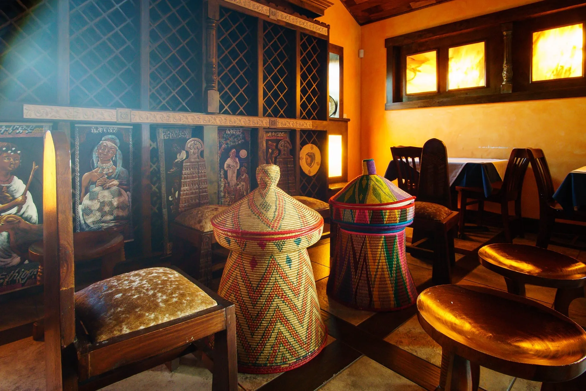 An intimate room with Ethiopian artwork and woven baskets at Blue Nile